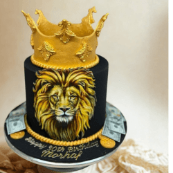 Black celebration cake with a hand-painted lion and gold crown